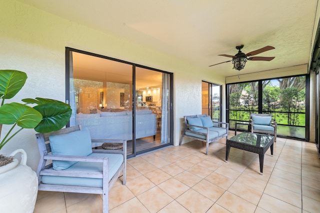 sunroom / solarium featuring a ceiling fan