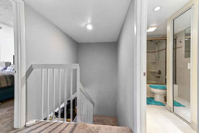 staircase featuring recessed lighting and tile patterned floors