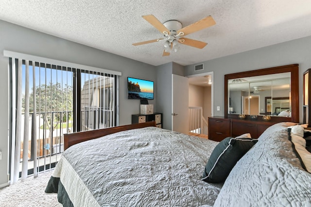 bedroom featuring access to exterior, carpet, visible vents, ceiling fan, and a textured ceiling