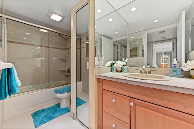 bathroom featuring recessed lighting, toilet, enclosed tub / shower combo, vanity, and tile patterned floors