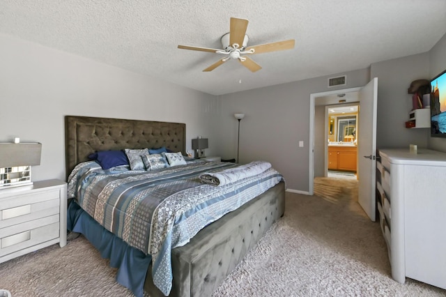 bedroom with light carpet, visible vents, a ceiling fan, a baseboard radiator, and a textured ceiling