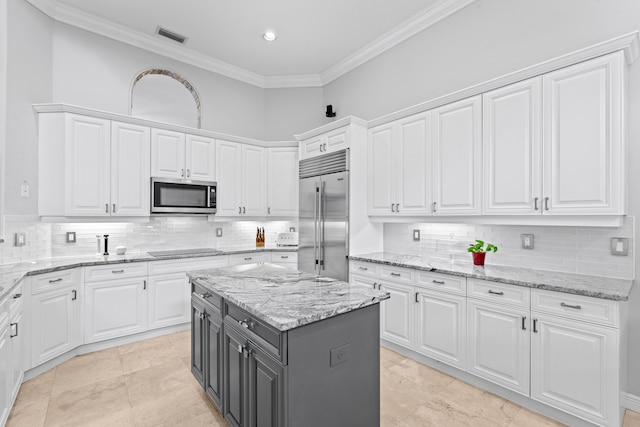 kitchen with crown molding, visible vents, decorative backsplash, appliances with stainless steel finishes, and white cabinets