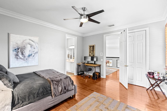 bedroom featuring ornamental molding, wood finished floors, visible vents, and a ceiling fan