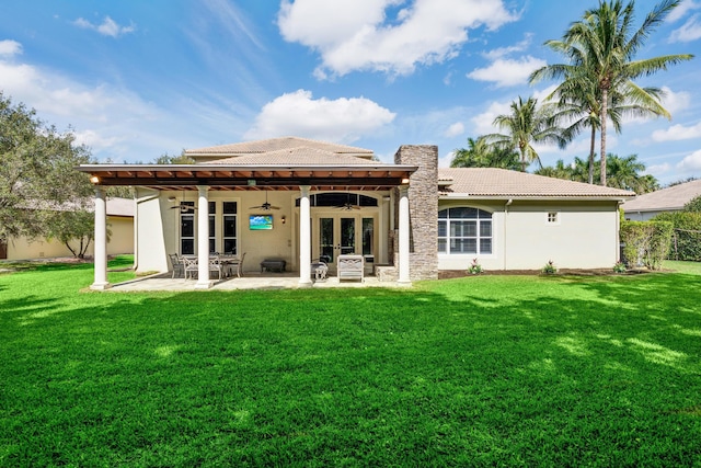 back of property with french doors, a patio, ceiling fan, a tile roof, and a yard