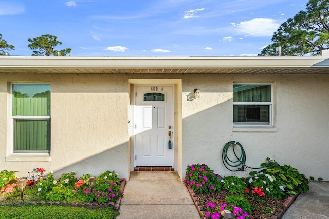 doorway to property with stucco siding