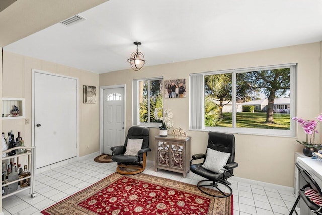 interior space featuring light tile patterned floors, baseboards, and visible vents