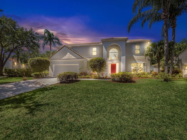 10282 Hunt Club Ln, Palm Beach Gardens, FL 33418 - mediterranean / spanish-style house featuring a tiled roof, an attached garage, concrete driveway, stucco siding, and a lawn