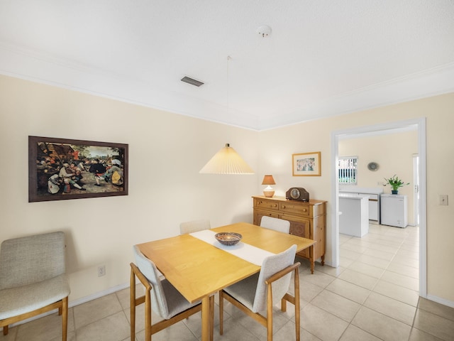 10282 Hunt Club Ln, Palm Beach Gardens, FL 33418 - dining space featuring light tile patterned floors, crown molding, and baseboards