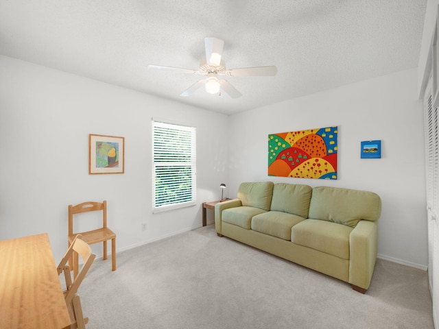10282 Hunt Club Ln, Palm Beach Gardens, FL 33418 - carpeted living room with a ceiling fan, baseboards, and a textured ceiling