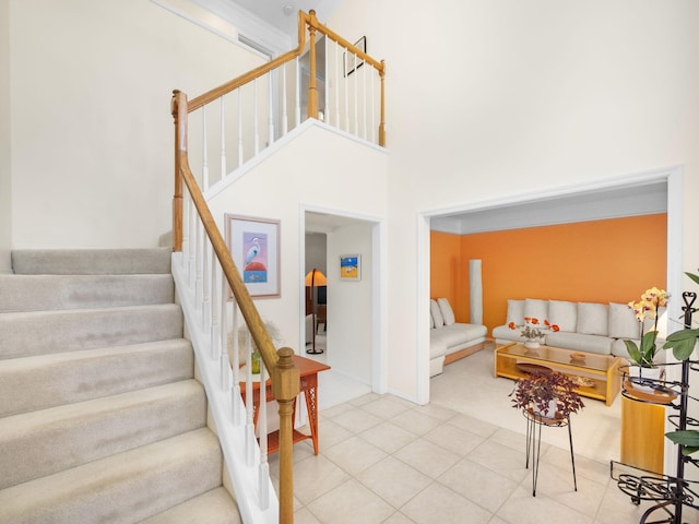 10282 Hunt Club Ln, Palm Beach Gardens, FL 33418 - staircase featuring a high ceiling and carpet