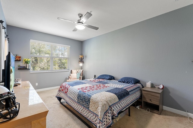 bedroom with baseboards, light carpet, and ceiling fan