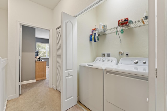 clothes washing area featuring laundry area, light colored carpet, and separate washer and dryer