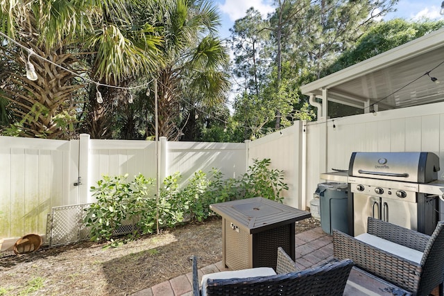 view of patio with a grill and a fenced backyard