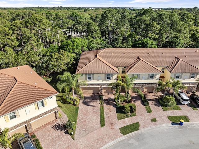 drone / aerial view with a wooded view