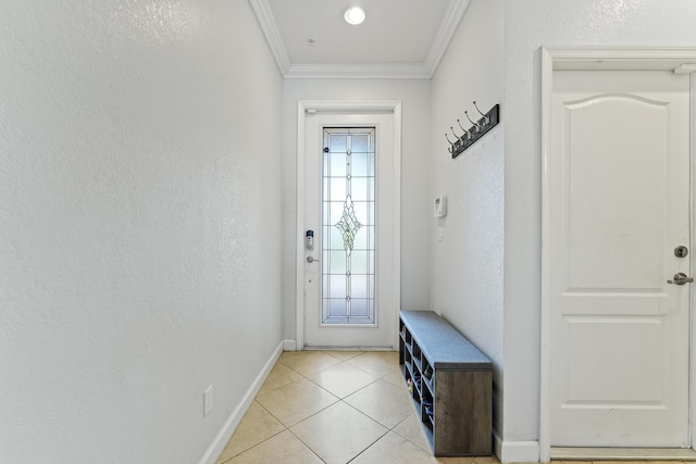 entryway with light tile patterned floors, a textured wall, and ornamental molding