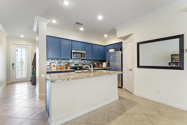 kitchen with blue cabinets, light stone counters, a sink, backsplash, and appliances with stainless steel finishes