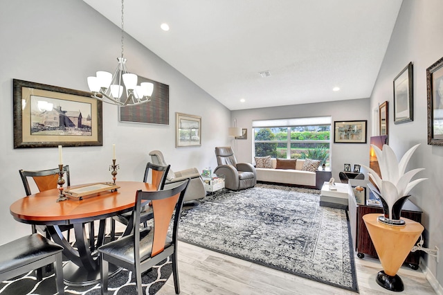 dining room featuring lofted ceiling, a notable chandelier, recessed lighting, wood finished floors, and visible vents