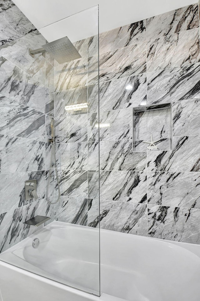 full bath featuring a combined bath / shower with marble appearance