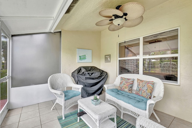 sunroom featuring ceiling fan and a wealth of natural light