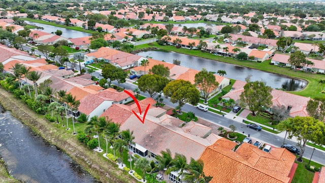 drone / aerial view with a residential view and a water view