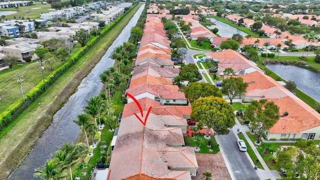 birds eye view of property with a water view and a residential view