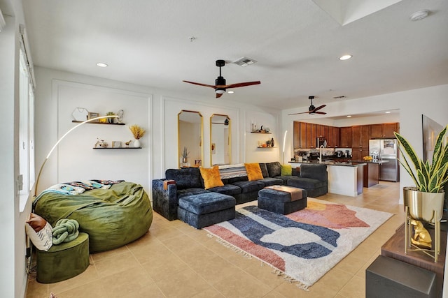 living room with light tile patterned floors, visible vents, and recessed lighting