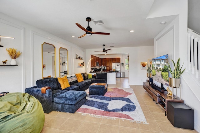 living area featuring light tile patterned flooring, visible vents, and recessed lighting