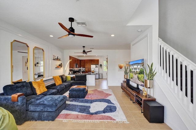 living area featuring stairs, recessed lighting, visible vents, and light tile patterned floors