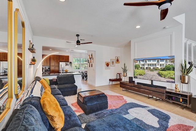 living area with light tile patterned floors, ceiling fan, and recessed lighting