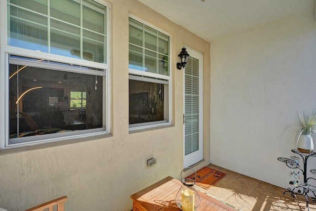 property entrance featuring a patio area and stucco siding