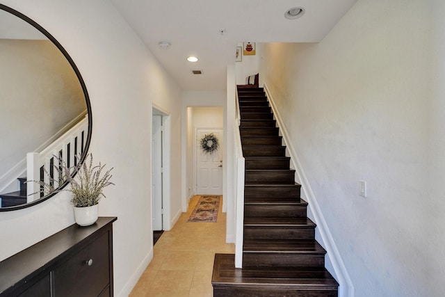 stairs with recessed lighting, visible vents, baseboards, and tile patterned floors