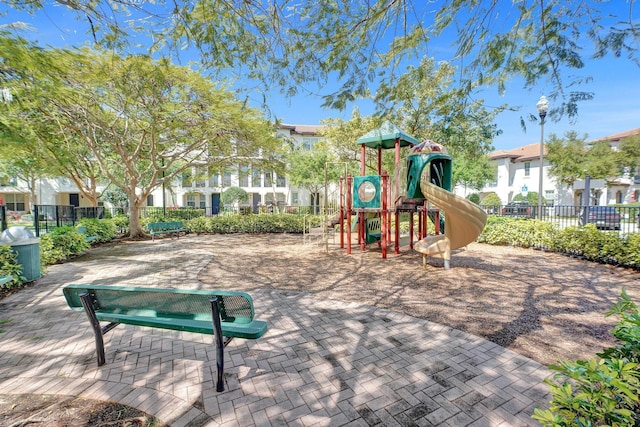 community jungle gym featuring fence and a residential view