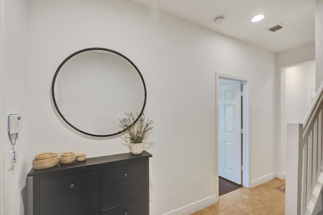 hall with recessed lighting, visible vents, baseboards, and light tile patterned flooring