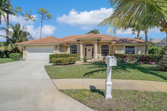 mediterranean / spanish-style house with a tile roof, stucco siding, an attached garage, driveway, and a front lawn