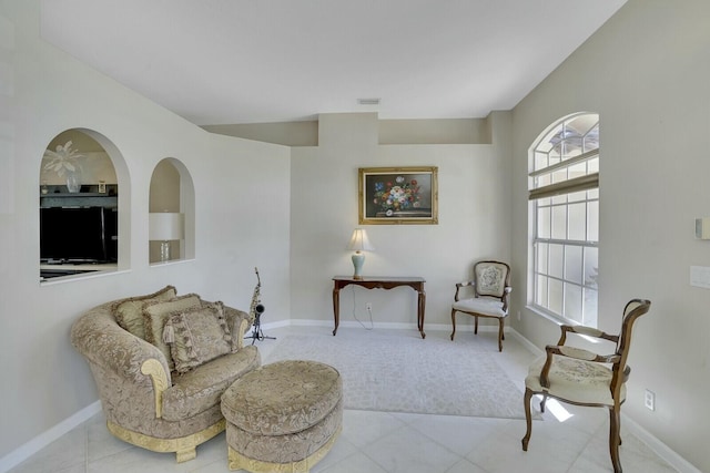 sitting room with visible vents, baseboards, and tile patterned floors