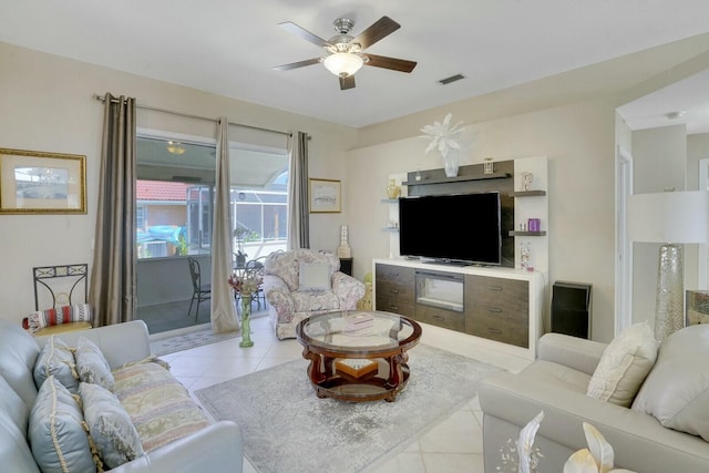 tiled living room with visible vents and a ceiling fan