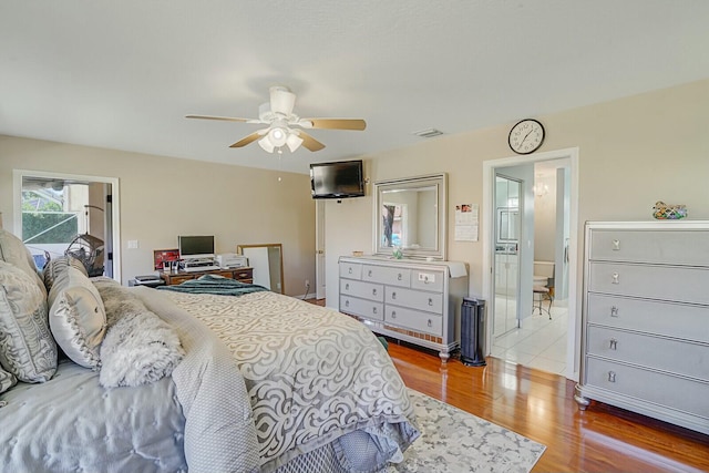 bedroom featuring ceiling fan, wood finished floors, and visible vents