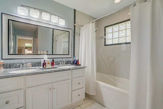 full bath with shower / tub combo, tile patterned floors, a sink, and double vanity