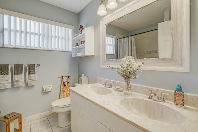 full bathroom featuring plenty of natural light, tile patterned flooring, and a sink