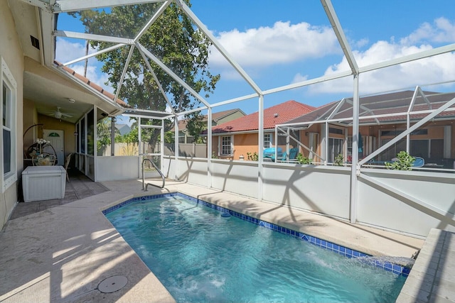 view of swimming pool featuring glass enclosure, fence, a fenced in pool, and a patio