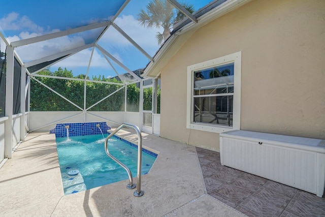 pool with glass enclosure and a patio area