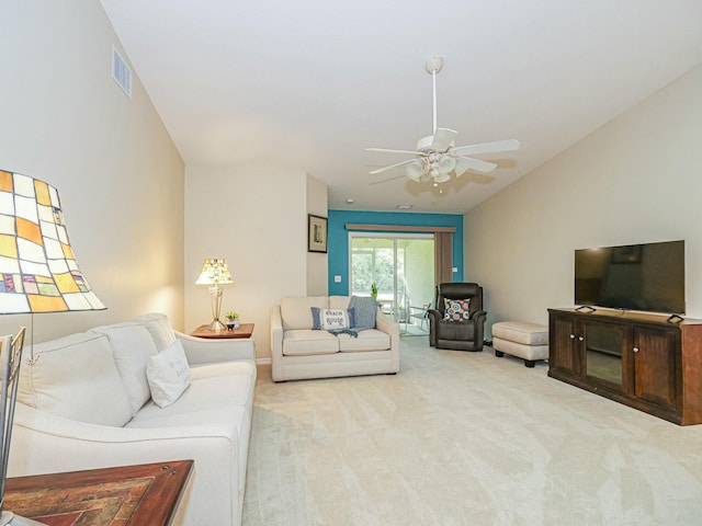 carpeted living room with lofted ceiling, a ceiling fan, and visible vents