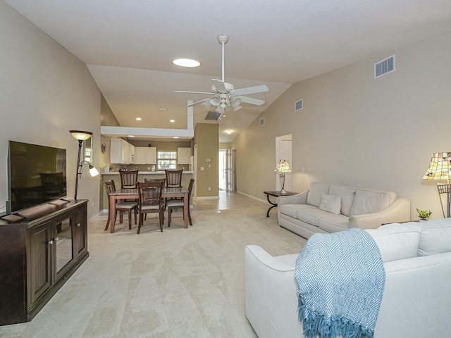 living area featuring visible vents, light colored carpet, a ceiling fan, and baseboards