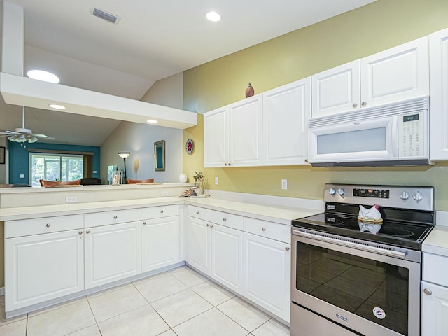 kitchen with white microwave, electric range, light countertops, and visible vents