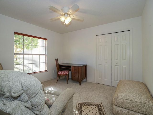 carpeted office with baseboards and ceiling fan