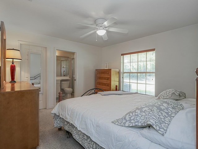 bedroom with connected bathroom, a ceiling fan, and carpet