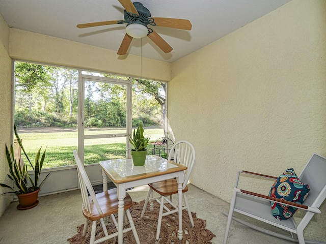 sunroom with a wealth of natural light and a ceiling fan