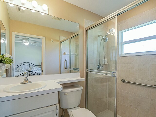946 S Easy St, Sebastian, FL 32958 - ensuite bathroom featuring toilet, connected bathroom, a shower stall, ceiling fan, and vanity