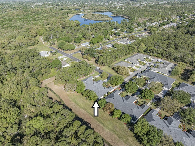 drone / aerial view with a residential view and a water view