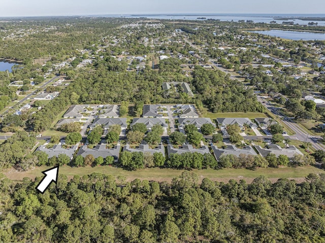 birds eye view of property with a residential view and a water view